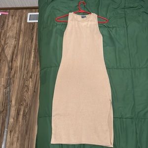 Long, tank top dress. Nude color, has a leg slit.